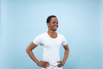 Image showing Half-length close up portrait of young man on blue background.