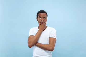 Image showing Half-length close up portrait of young man on blue background.