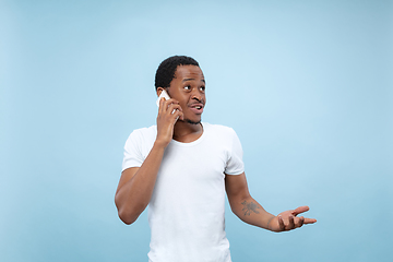 Image showing Half-length close up portrait of young man on blue background.