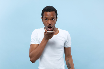 Image showing Half-length close up portrait of young man on blue background.