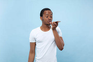 Image showing Half-length close up portrait of young man on blue background.