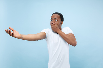 Image showing Half-length close up portrait of young man on blue background.