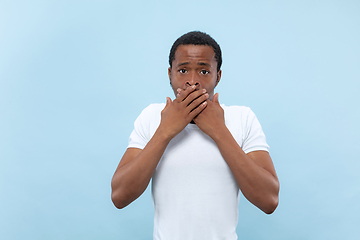 Image showing Half-length close up portrait of young man on blue background.