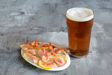 Image showing Glass of light beer on white stone background