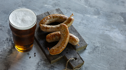 Image showing Glass of beer on white stone background