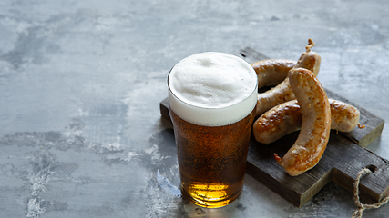 Image showing Glass of beer on white stone background