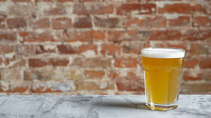 Image showing Glass of light beer on white stone background