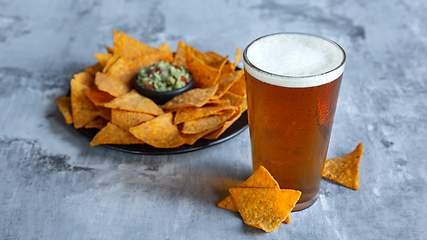 Image showing Glass of light beer on white stone background