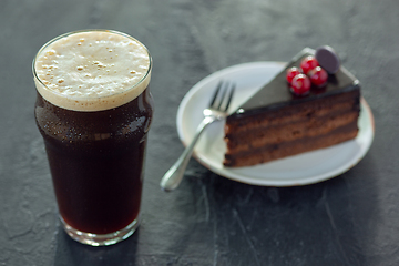 Image showing Glass of dark beer on the stone table background