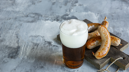 Image showing Glass of beer on white stone background