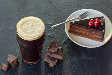 Image showing Glass of dark beer on the stone table background