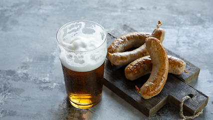 Image showing Glass of beer on white stone background