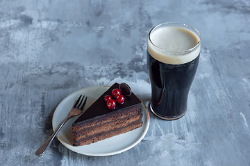 Image showing Glass of dark beer on the stone table background