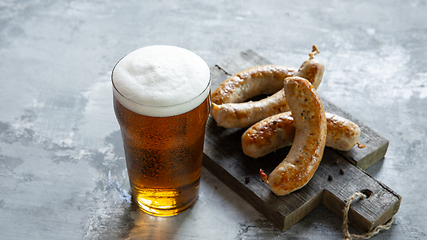 Image showing Glass of beer on white stone background