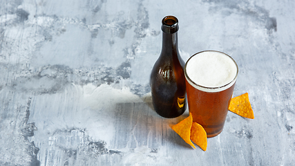 Image showing Glass of light beer on white stone background