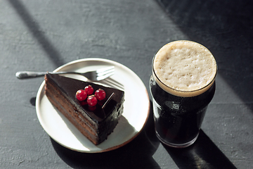 Image showing Glass of dark beer on the stone table background