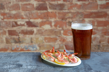 Image showing Glass of light beer on white stone background