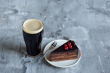 Image showing Glass of dark beer on the stone table background