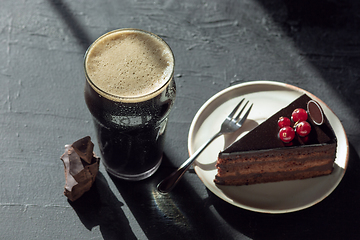 Image showing Glass of dark beer on the stone table background