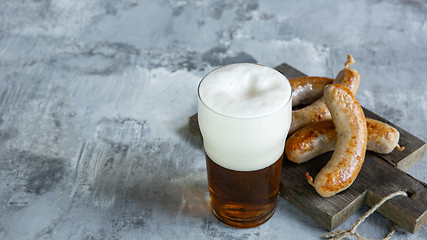 Image showing Glass of beer on white stone background