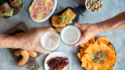 Image showing Top view of beer glasses with foam on top and delicious snacks