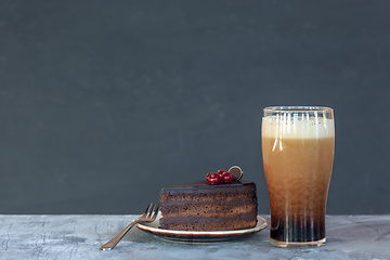 Image showing Glass of dark beer on the stone table background