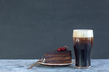 Image showing Glass of dark beer on the stone table background