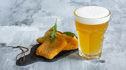 Image showing Glass of light beer on white stone background