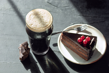 Image showing Glass of dark beer on the stone table background