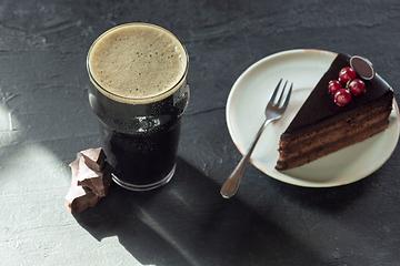 Image showing Glass of dark beer on the stone table background