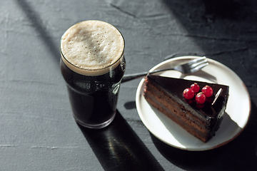 Image showing Glass of dark beer on the stone table background