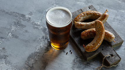 Image showing Glass of beer on white stone background