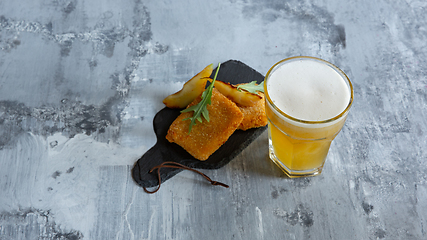 Image showing Glass of light beer on white stone background