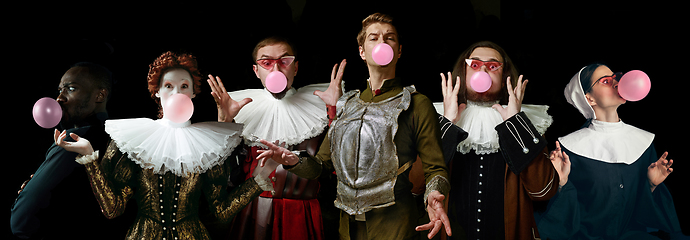 Image showing Young people as a medieval knights or grandees on dark background