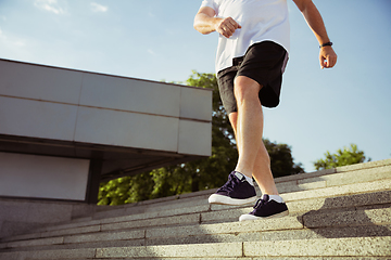 Image showing Senior man as runner with armband or fitness tracker at the city\'s street