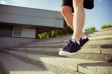 Image showing Senior man as runner with armband or fitness tracker at the city\'s street