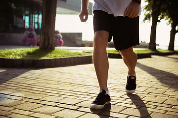 Image showing Senior man as runner with armband or fitness tracker at the city\'s street