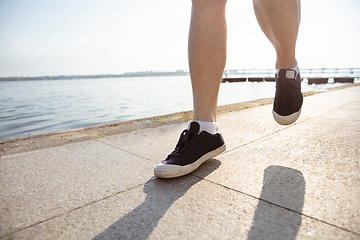 Image showing Senior man as runner with armband or fitness tracker at the riverside