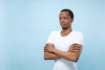 Image showing Half-length close up portrait of young man on blue background.