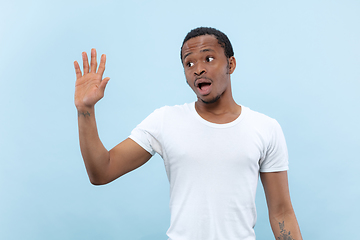 Image showing Half-length close up portrait of young man on blue background.