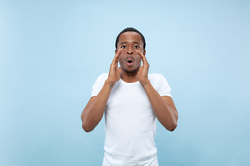 Image showing Half-length close up portrait of young man on blue background.