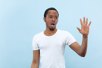 Image showing Half-length close up portrait of young man on blue background.