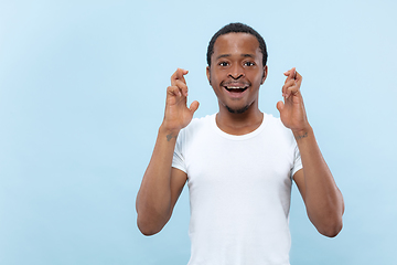 Image showing Half-length close up portrait of young man on blue background.