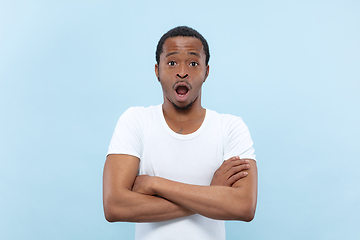 Image showing Half-length close up portrait of young man on blue background.