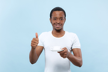 Image showing Half-length close up portrait of young man on blue background.