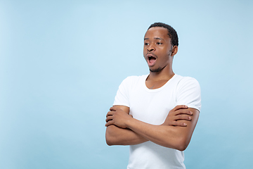 Image showing Half-length close up portrait of young man on blue background.