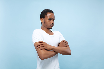 Image showing Half-length close up portrait of young man on blue background.