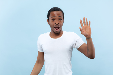 Image showing Half-length close up portrait of young man on blue background.