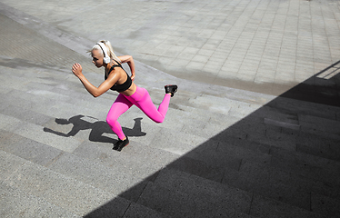 Image showing A young athletic woman working out at the city\'s street