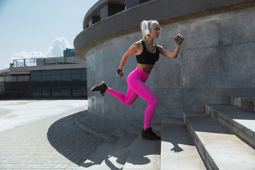 Image showing A young athletic woman working out at the city\'s street